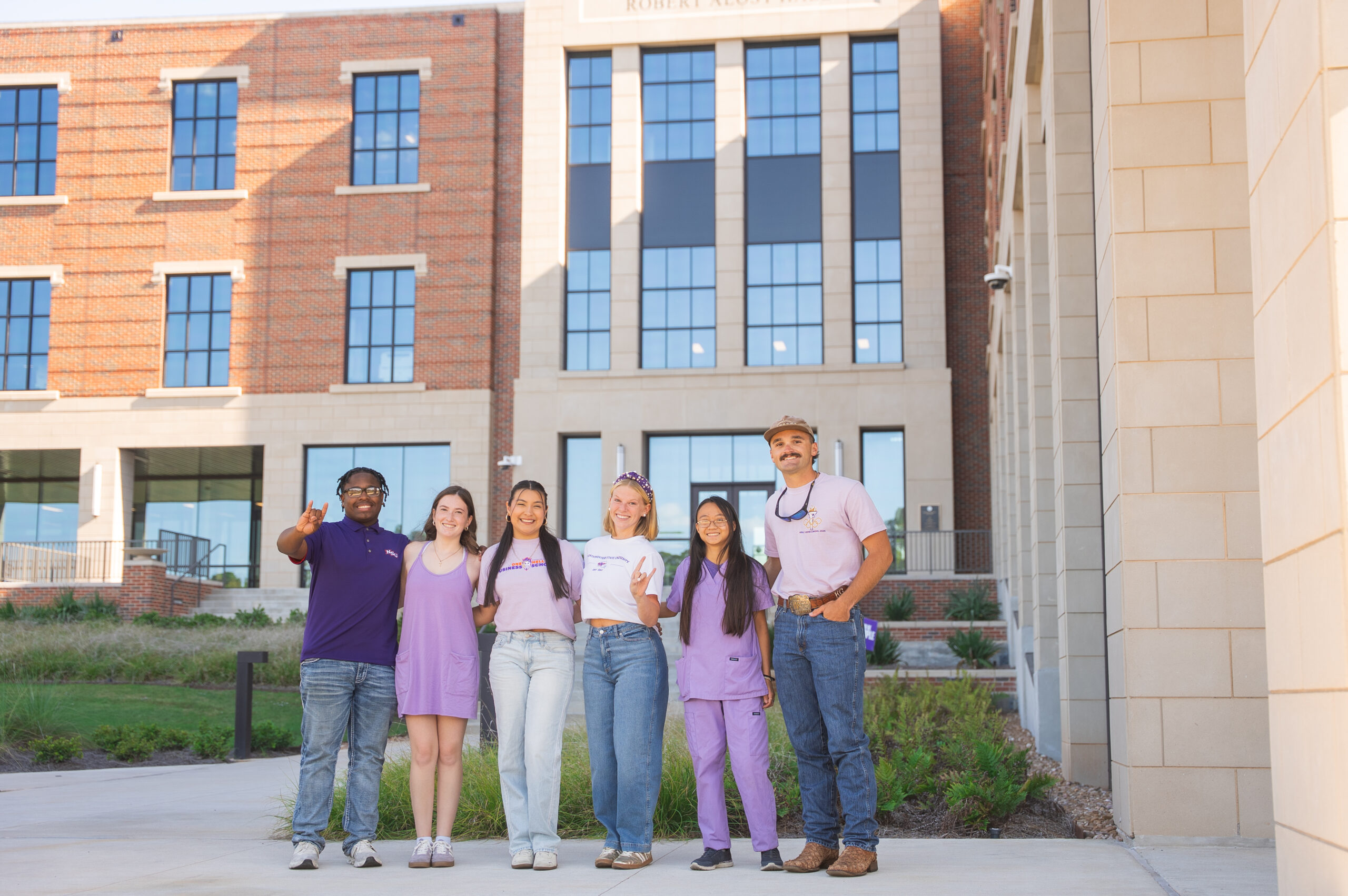 Group of six students in front of alost hall