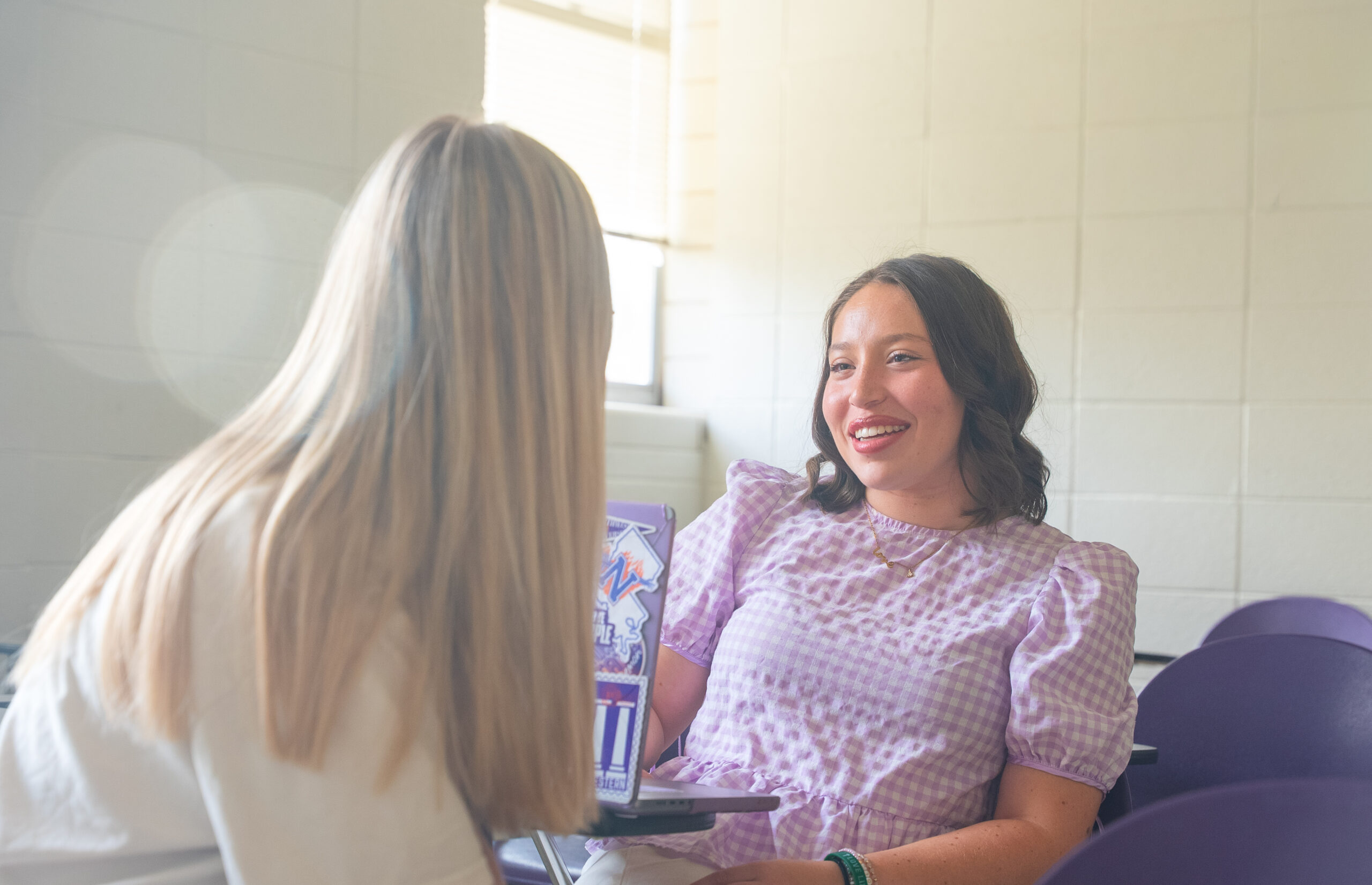 NSU student talking and smiling at another student