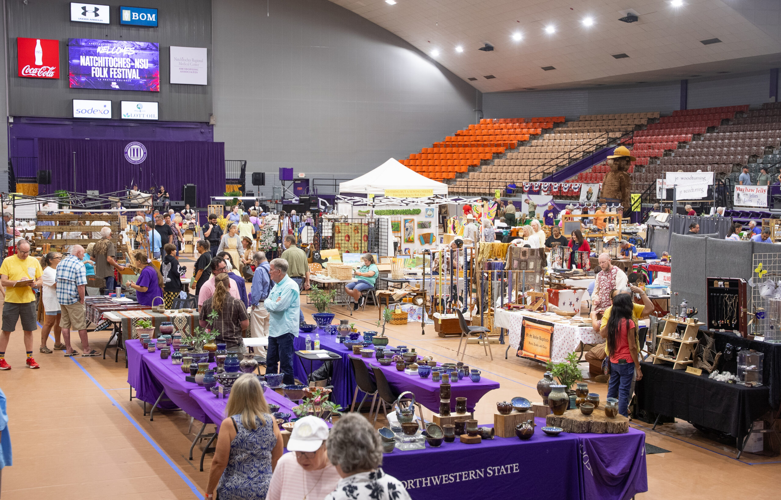 Visitors browse exhibits and handcrafted goods during the 46th Annual Natchitoches-NSU Folk Festival at Prather Coliseum on July 18.