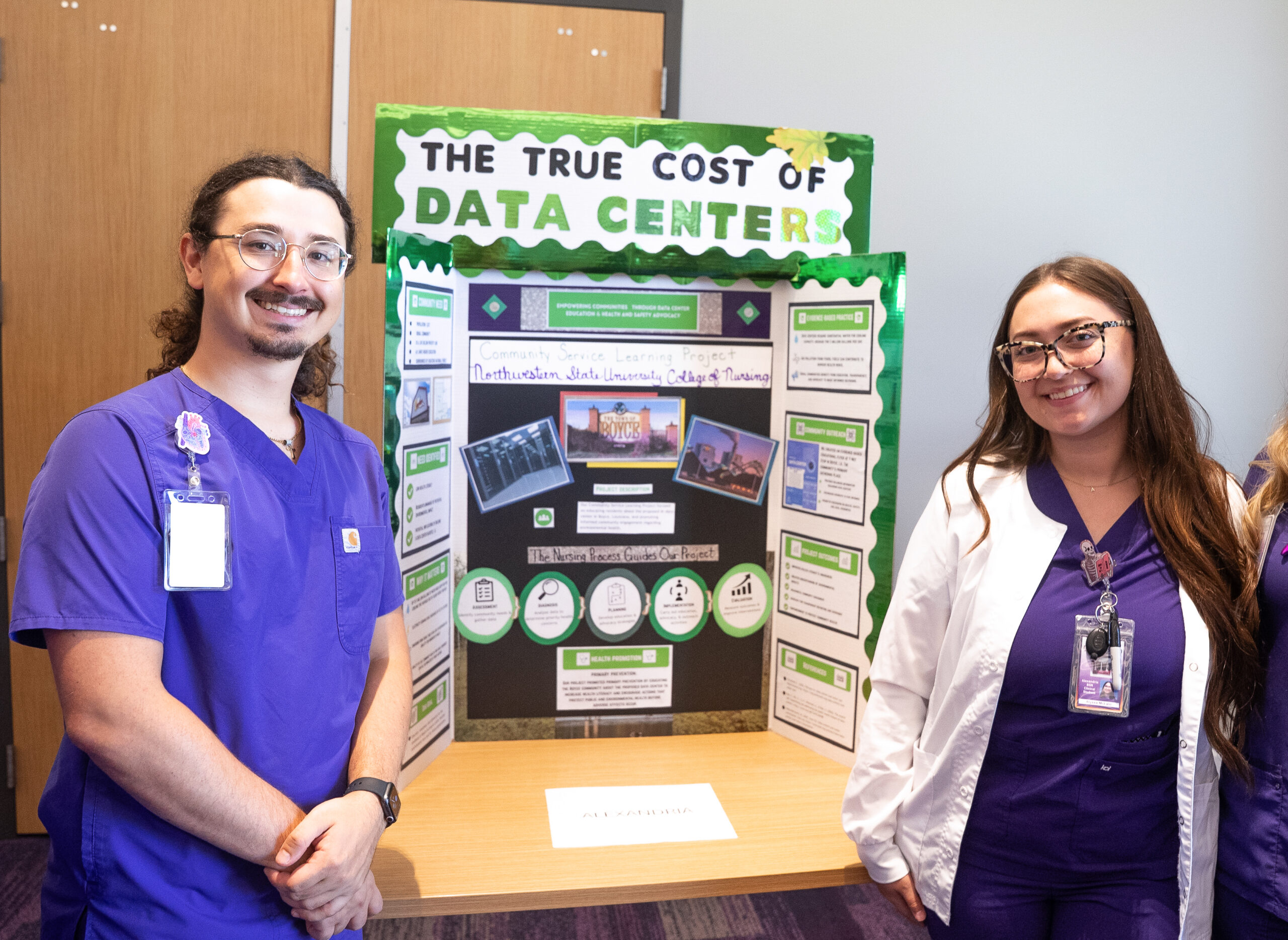Senior Bachelor of Science in Nursing students Matthew Delrie, left, and Alyssa McLain present their community impact project on the Boyce data center during Level 5 presentations.
