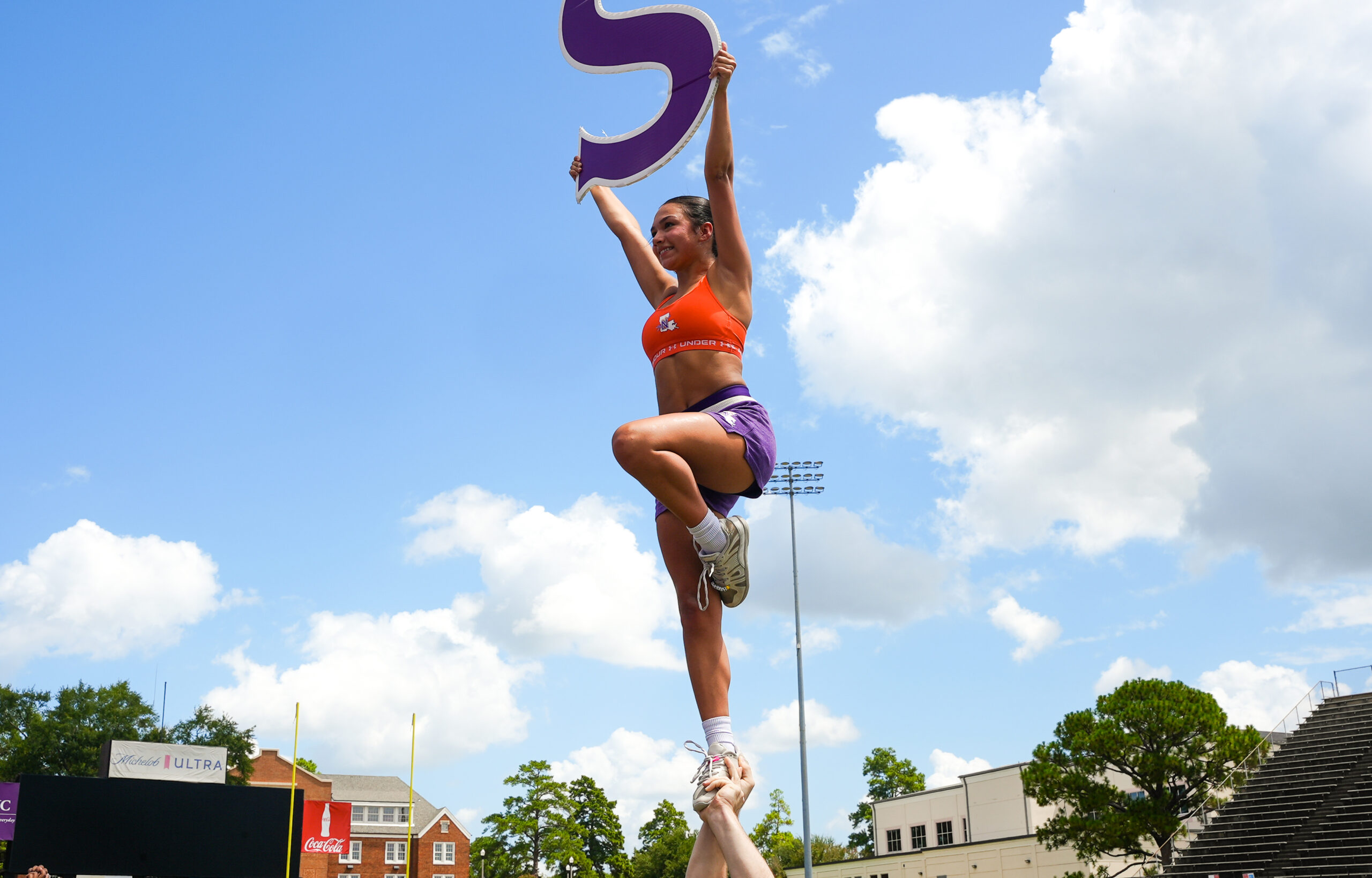 NSU Cheer member Sofia Albores performs a stunt during practice as the team prepares for the fall football season.