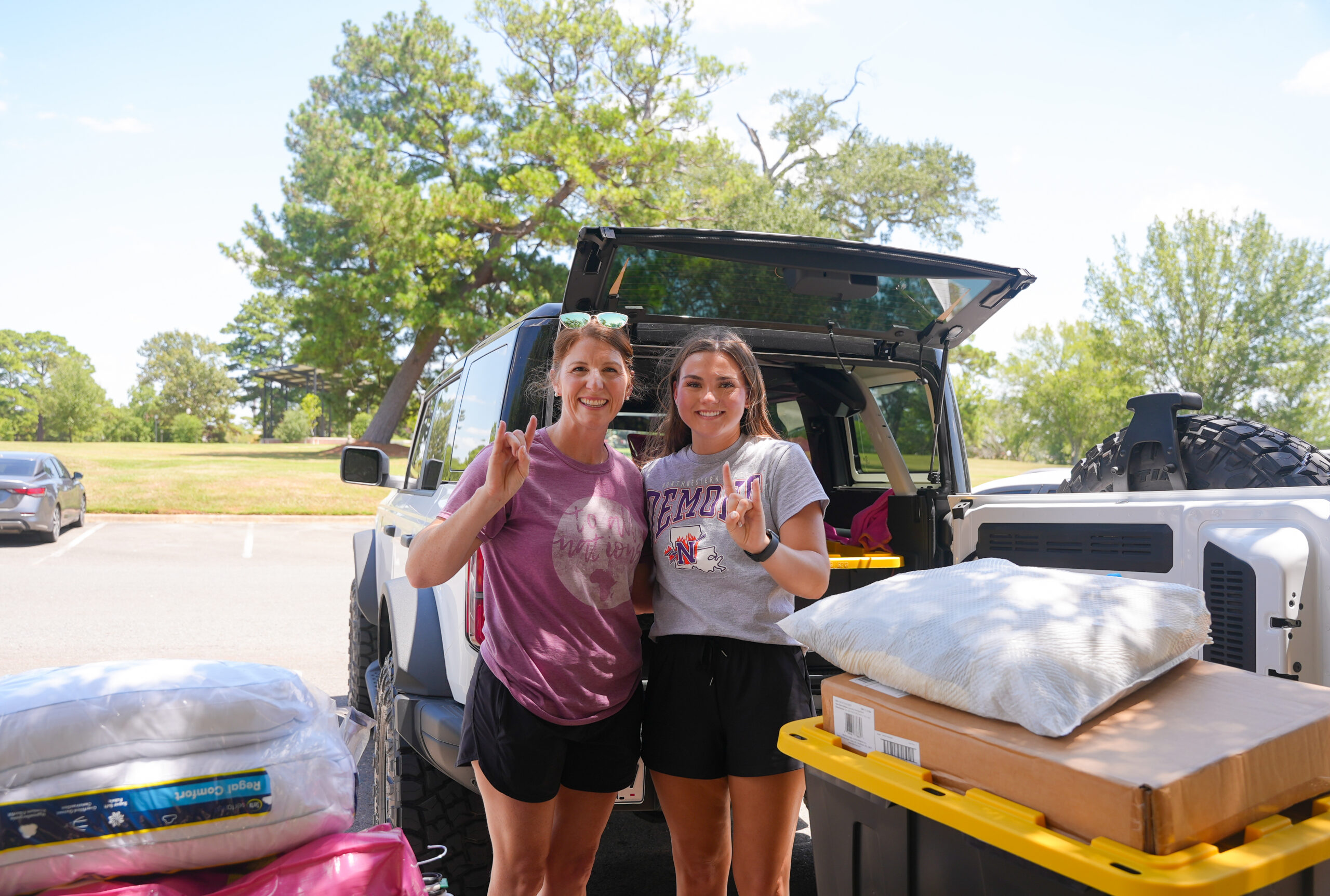 Incoming Northwestern State University first-year student Anna Baggett, left, and her mother, Stephanie Baggett, pose for a photo while moving Anna into University Place Thursday, Aug. 13.