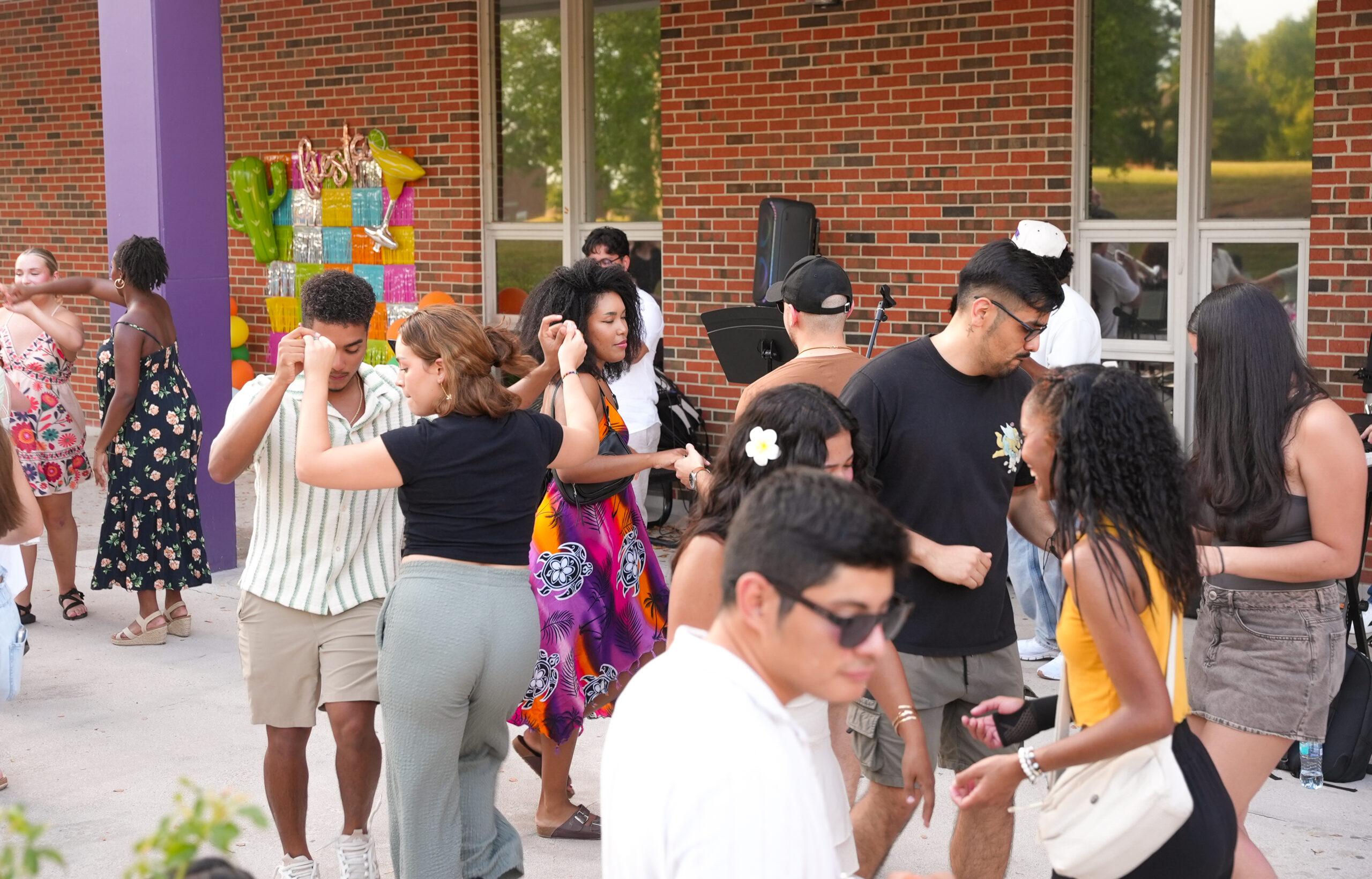 Siesta Fiesta attendees dance as a student band performs in the Student Union Plaza.