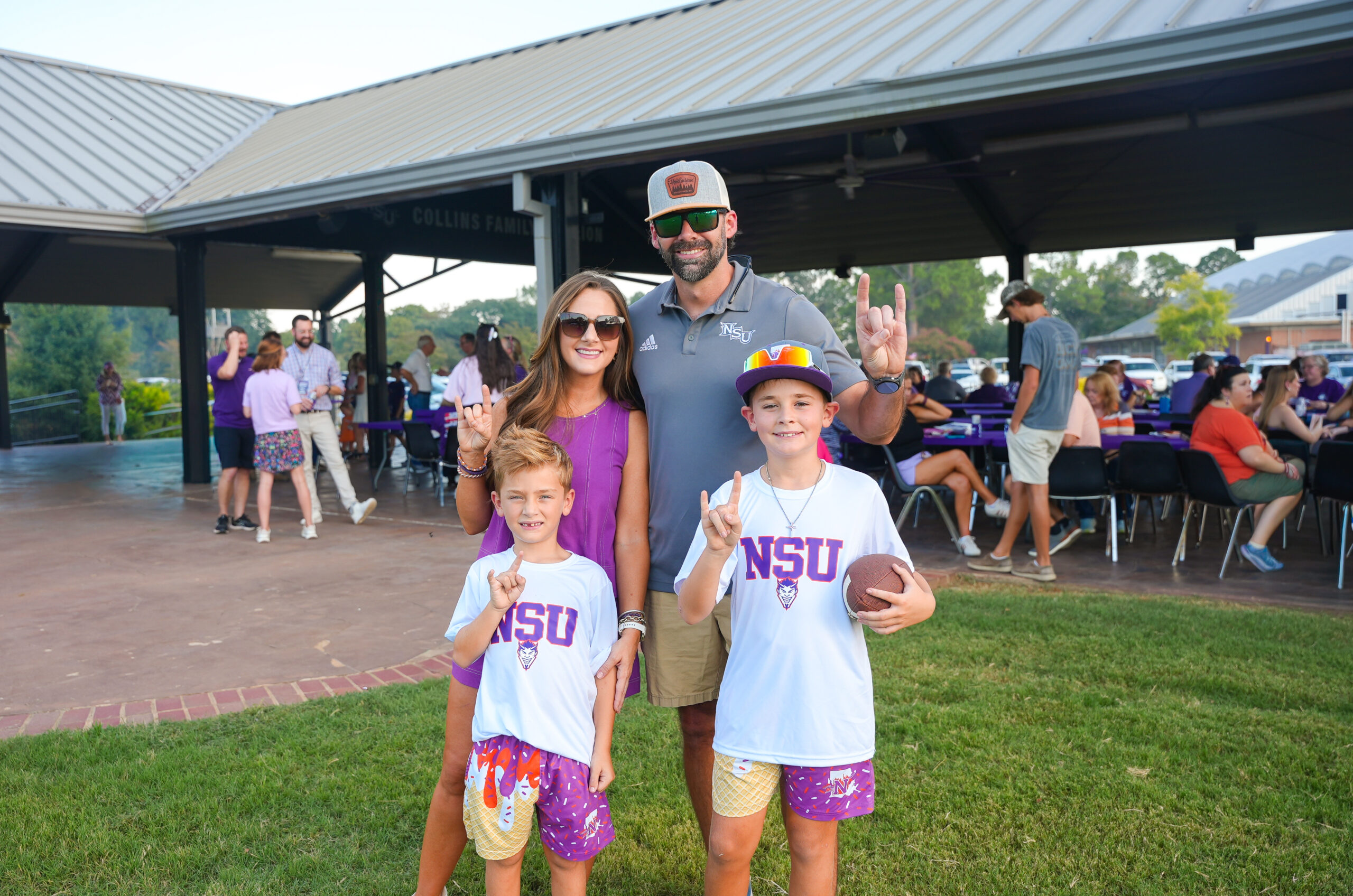 Tiffany and Michael Chasteen, with their sons Harrison and Graham, gather at the NSU Tailgate Field before a Northwestern State football game.