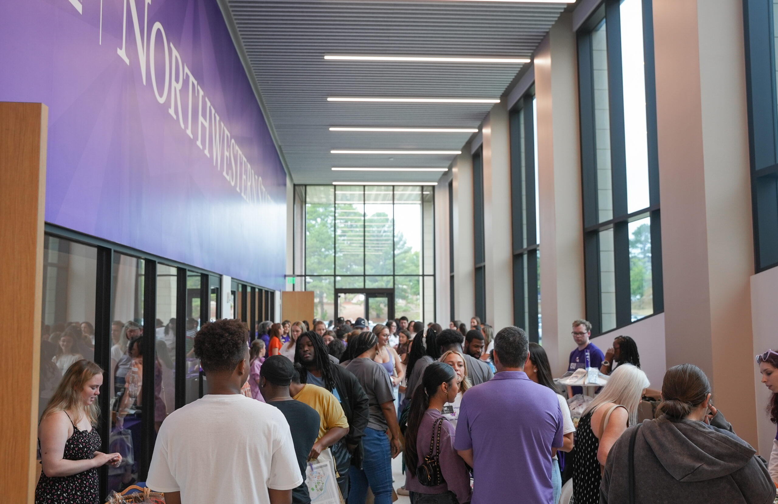 Prospective students and family members explore university programs and resources in Alost Hall during Northwestern State University’s N-Side View Day.