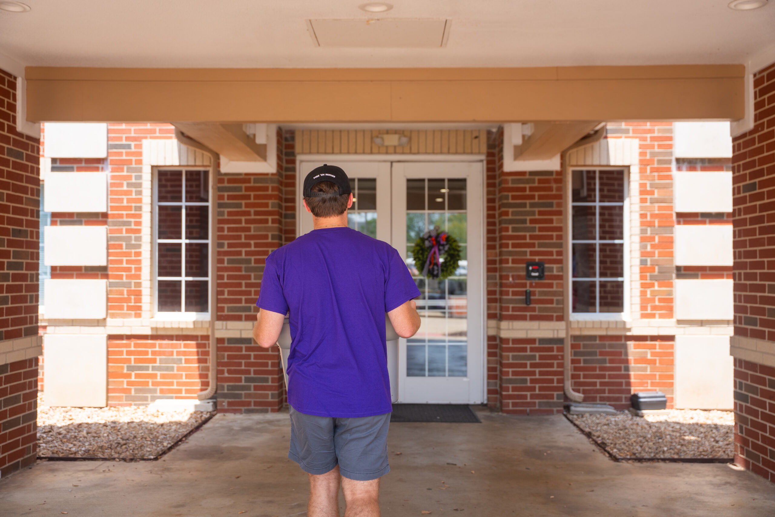 NSU student carrying box walking into university residence halls