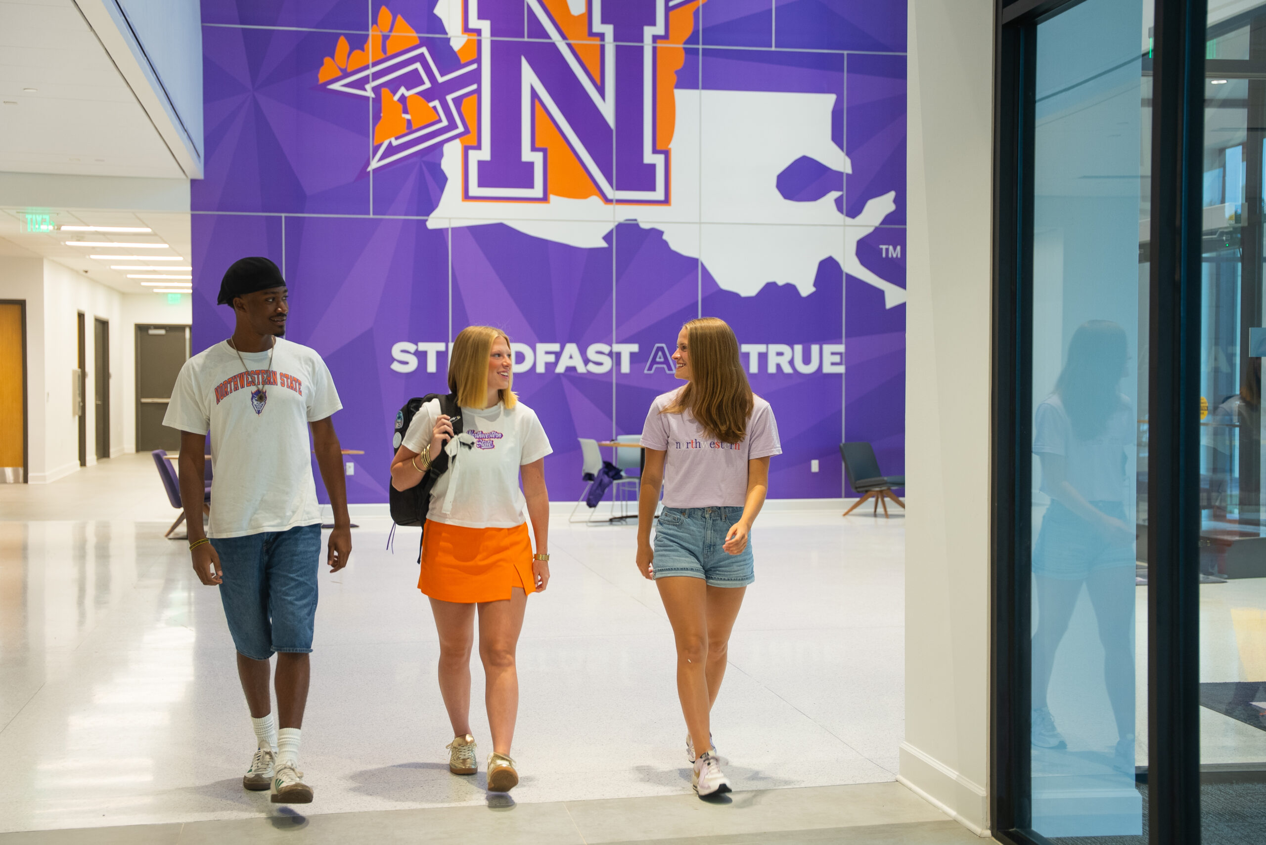 three students walking in Alost Hall together
