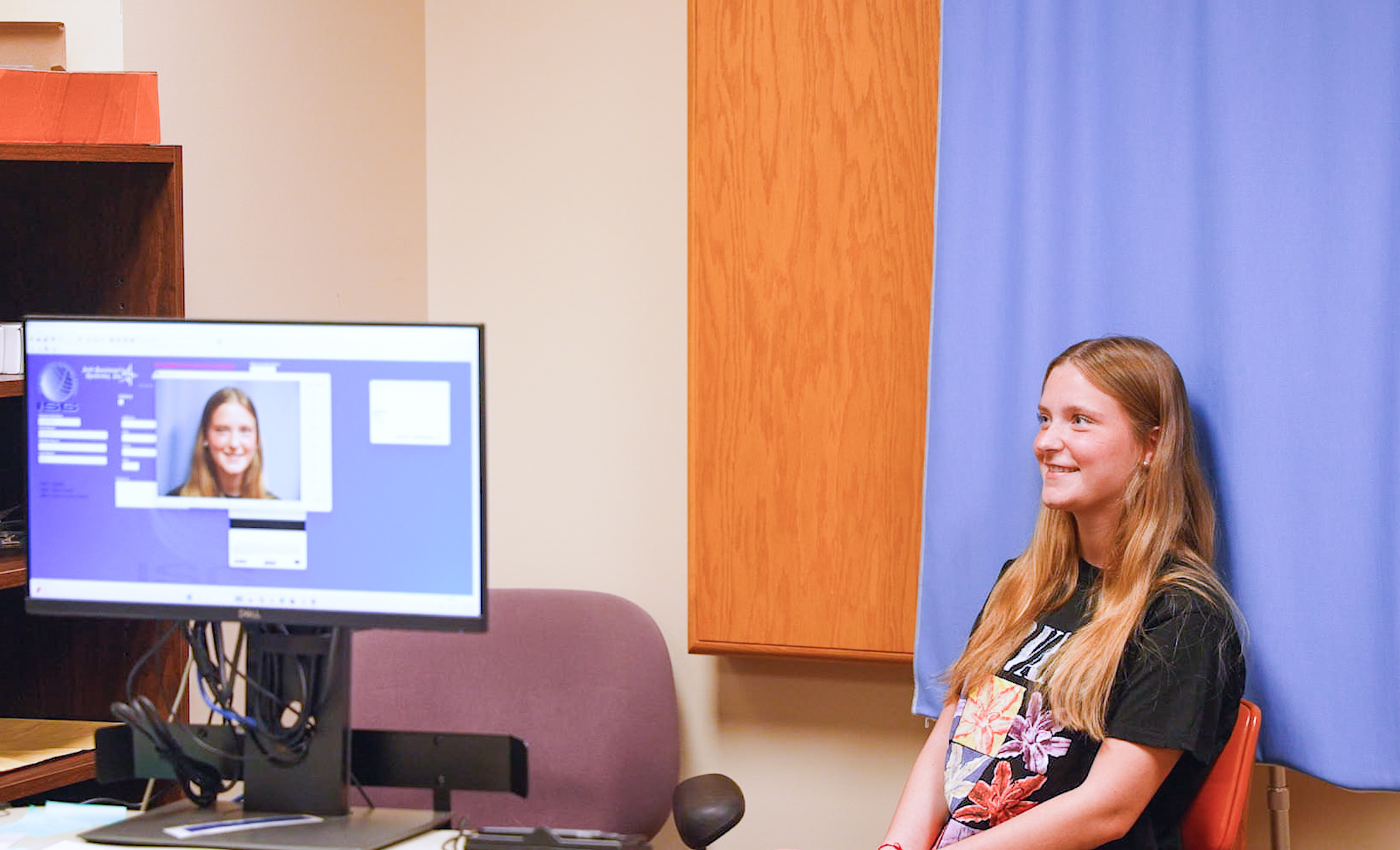 Incoming Northwestern State University student Addison Berg poses for her student identification card photo during registration at NSU's Shreveport campus.