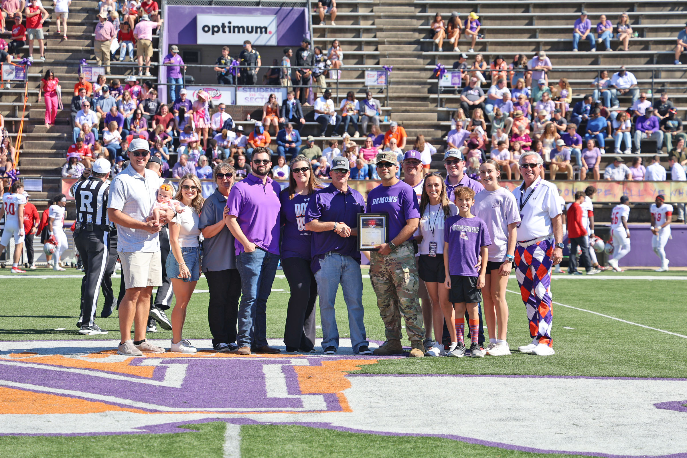 Sergeant Major (SGM) Blake Fowler was joined by his family for the coin toss at Northwestern State University’s Oct. 24 Homecoming football game. From left are Justin Krouse, Mollie Krouse, Sydney Krouse, Kristi Salard, Scott Fowler, Kara Fowler, SGM Blake Fowler, U.S. Army Captain Armando Lopez, head of NSU’s Department of Military Science; Blake Graves, Haley Graves, Preston Fowler, Easton Graves, Kinsley Graves and NSU President James Genovese.
