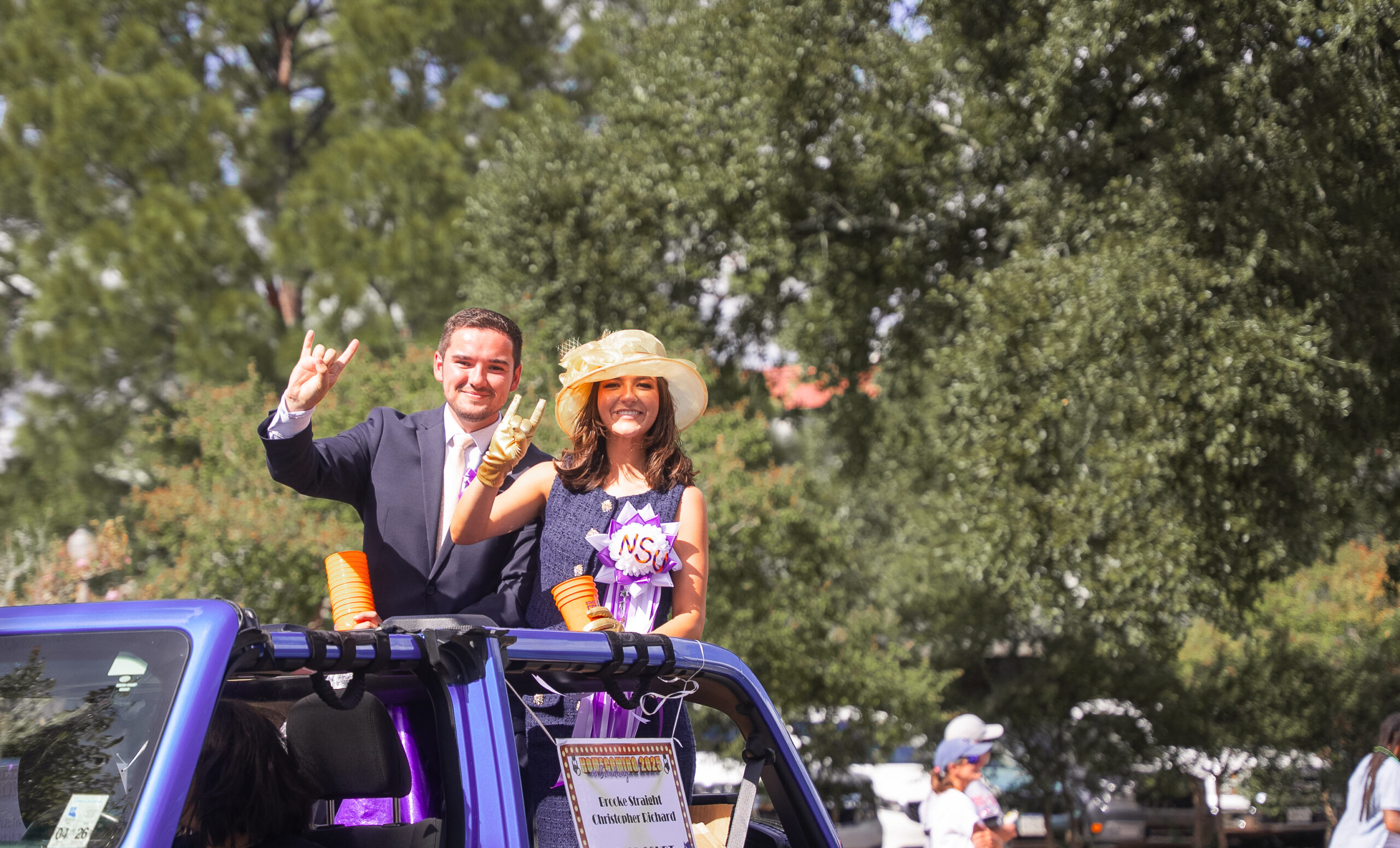 Christopher Richard, left, and Brooke Straight ride in Northwestern State University's 2025 Homecoming Parade as students. Both returned to their alma mater this year to begin professional careers serving students and the university community.