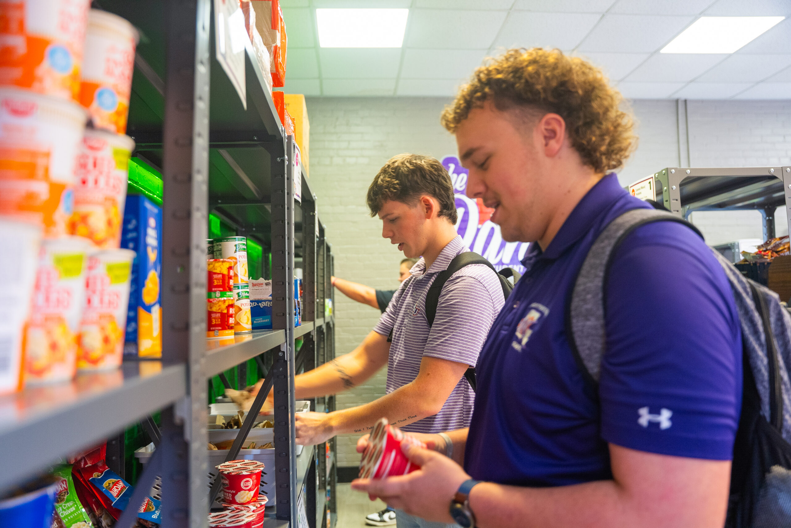 Aiden Mathews, left, and Joshua Decker select items from the NSU Food Pantry, which provides supplemental food and hygiene assistance to actively enrolled Northwestern State University students.