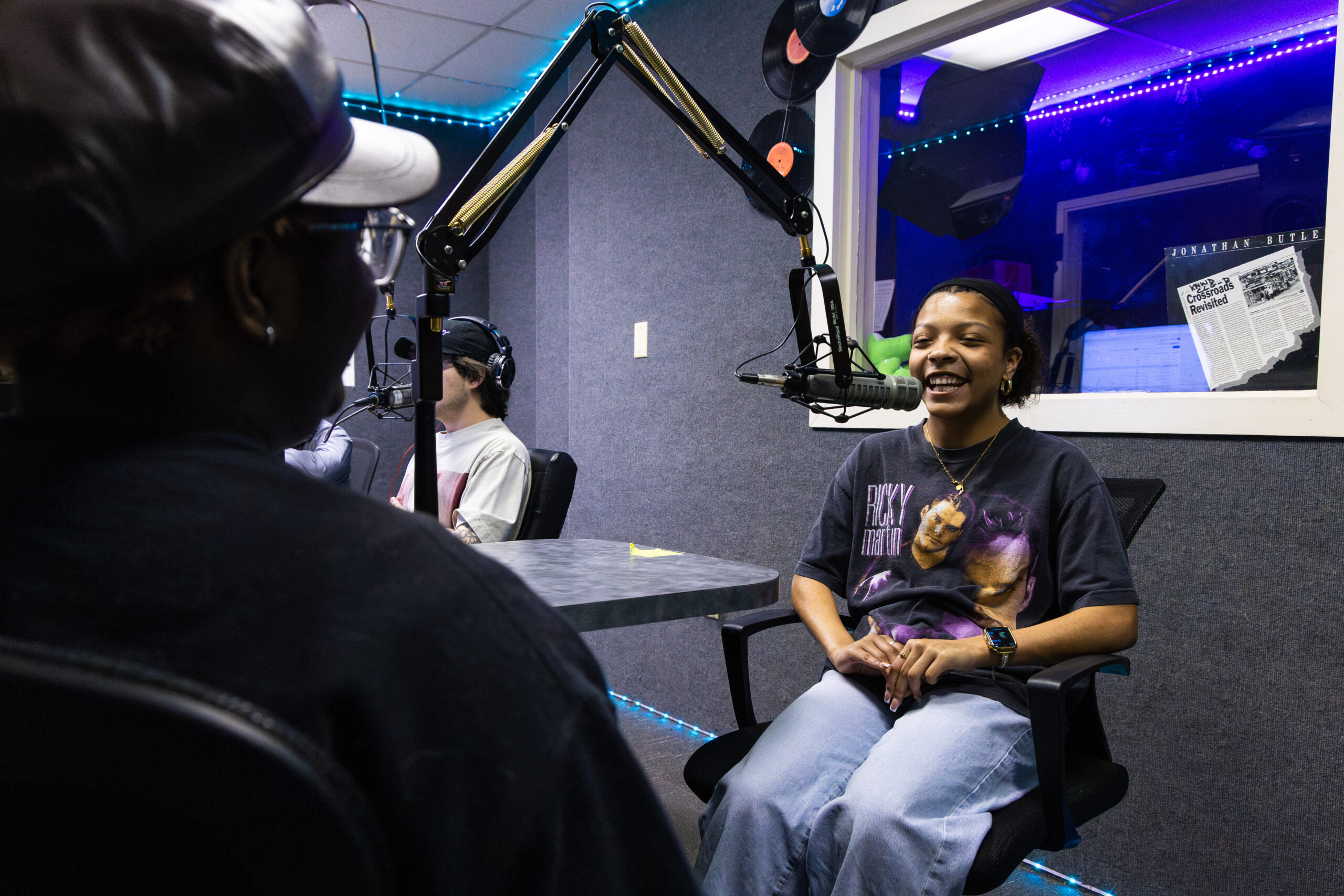 students in the radio studio together talking on microphones