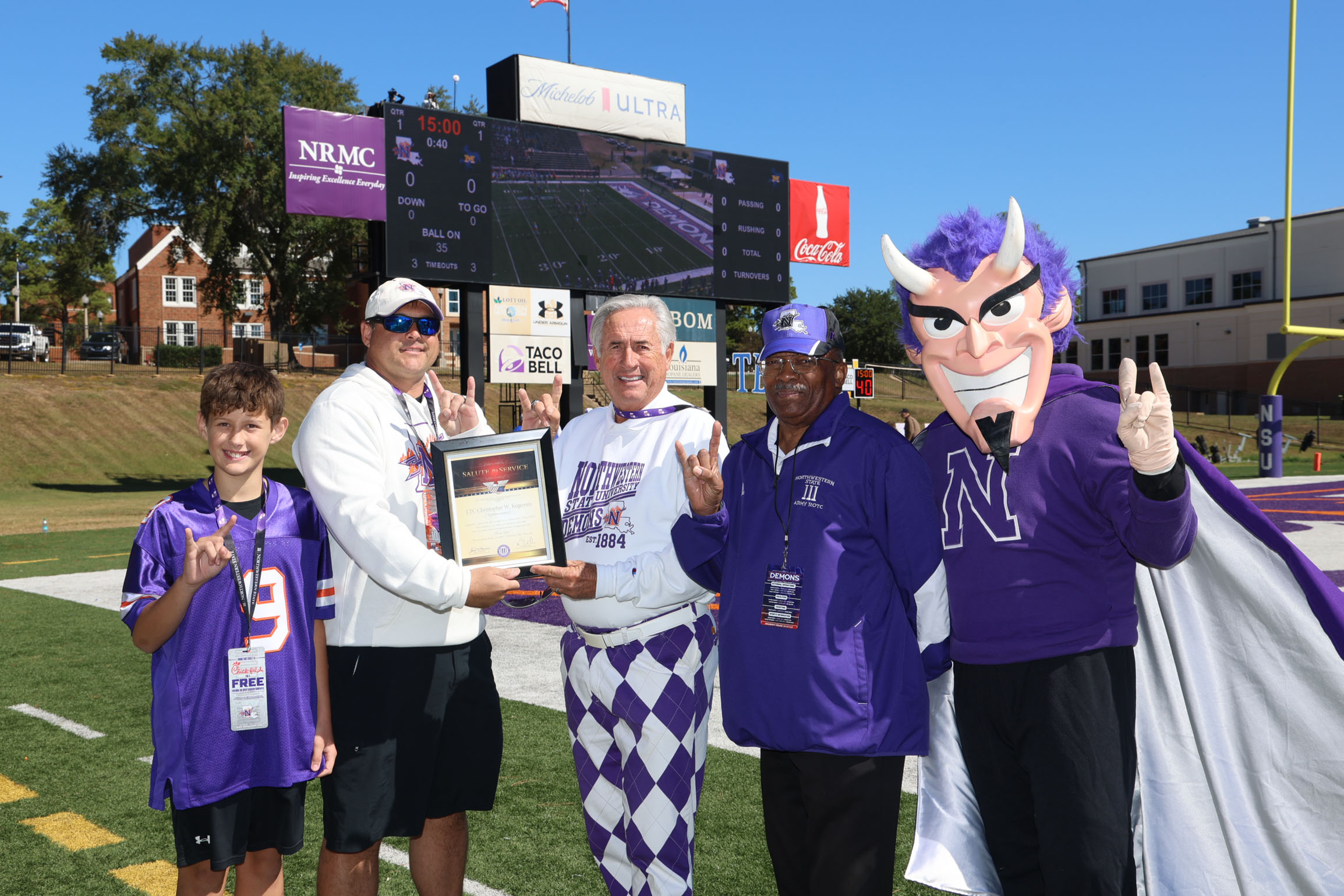 Lieutenant Colonel (LTC) Christopher W. Kegerreis as the honorary captain during NSU’s Oct. 17 football game. From left are Baylen Kegerreis, Kegerreis, NSU President James Genovese, LTC Retired Arthur Smalley and Vic the Demon.