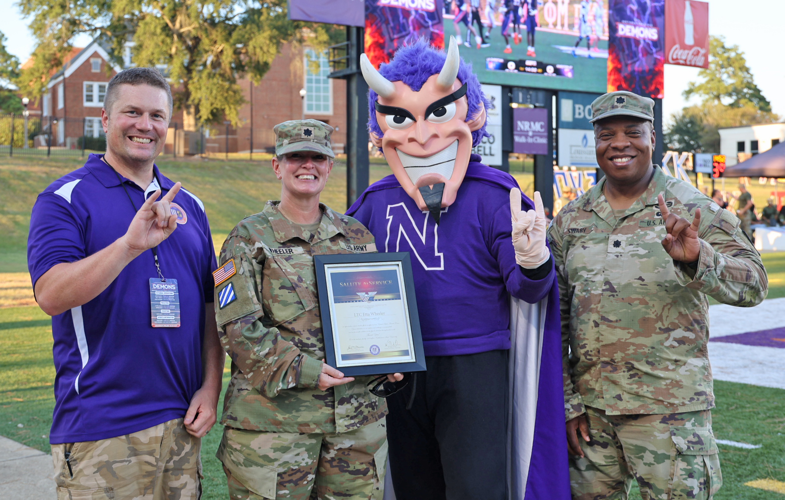 LTC Etta Wheeler was the honorary captain during NSU’s football game against Louisiana Christian University Aug. 27. From left are MSG Michael Blakeley, Wheeler, Vic the Demon and SLTC Tyrek Swaby.