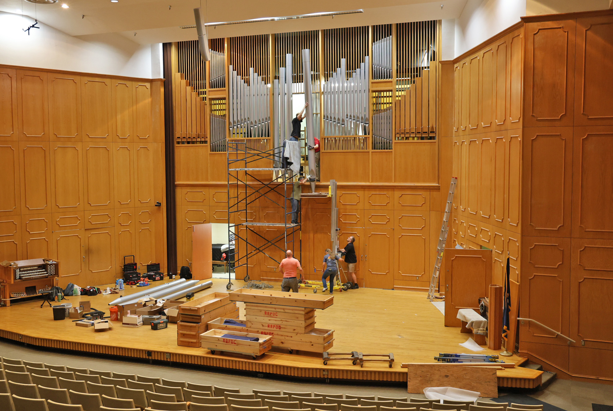 The Reuter Organ Company team worked together to manually install the NSU pipe organ’s largest pipes. On the floor from left are Kody Goad, JR Neutel and Billie Meyer. Jeff Noll is mid-scaffold and Fisher Neufeld and Joseph Riester are at the top.