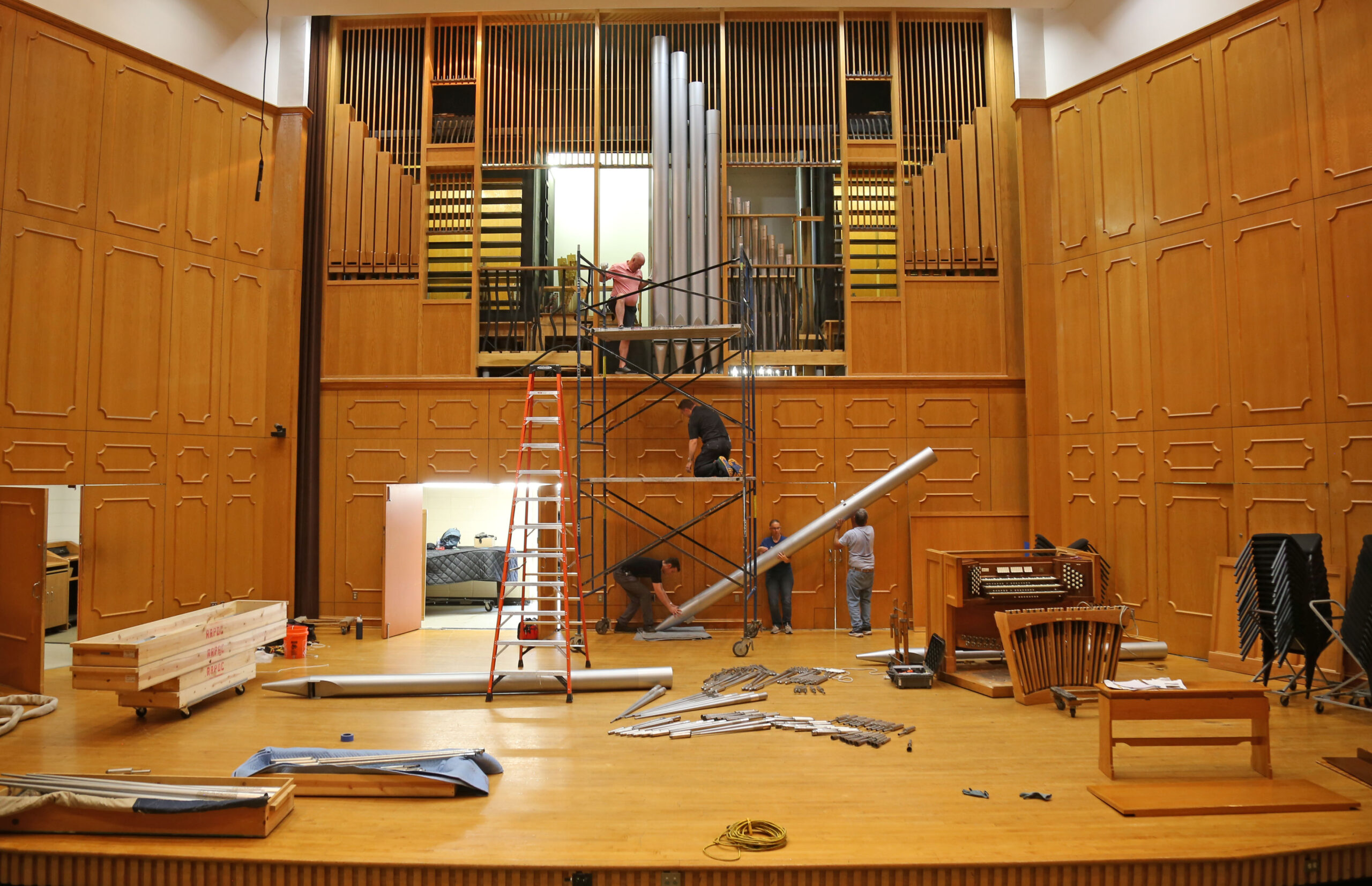 Organ Master and President of Reuter Organ Company JR Neutel, top of scaffold, worked with four assistants to manually remove the largest pipe, which weighs about 300 pounds, from NSU’s famed pipe organ. The instrument’s components are now on their way to Lawrence, Kansas, where they will be cleaned and upgraded, to be reinstalled at NSU later this summer. Giving opportunities to support the organ renovation are available at https://northwesternstatealumni.com/organ-restoration/.
