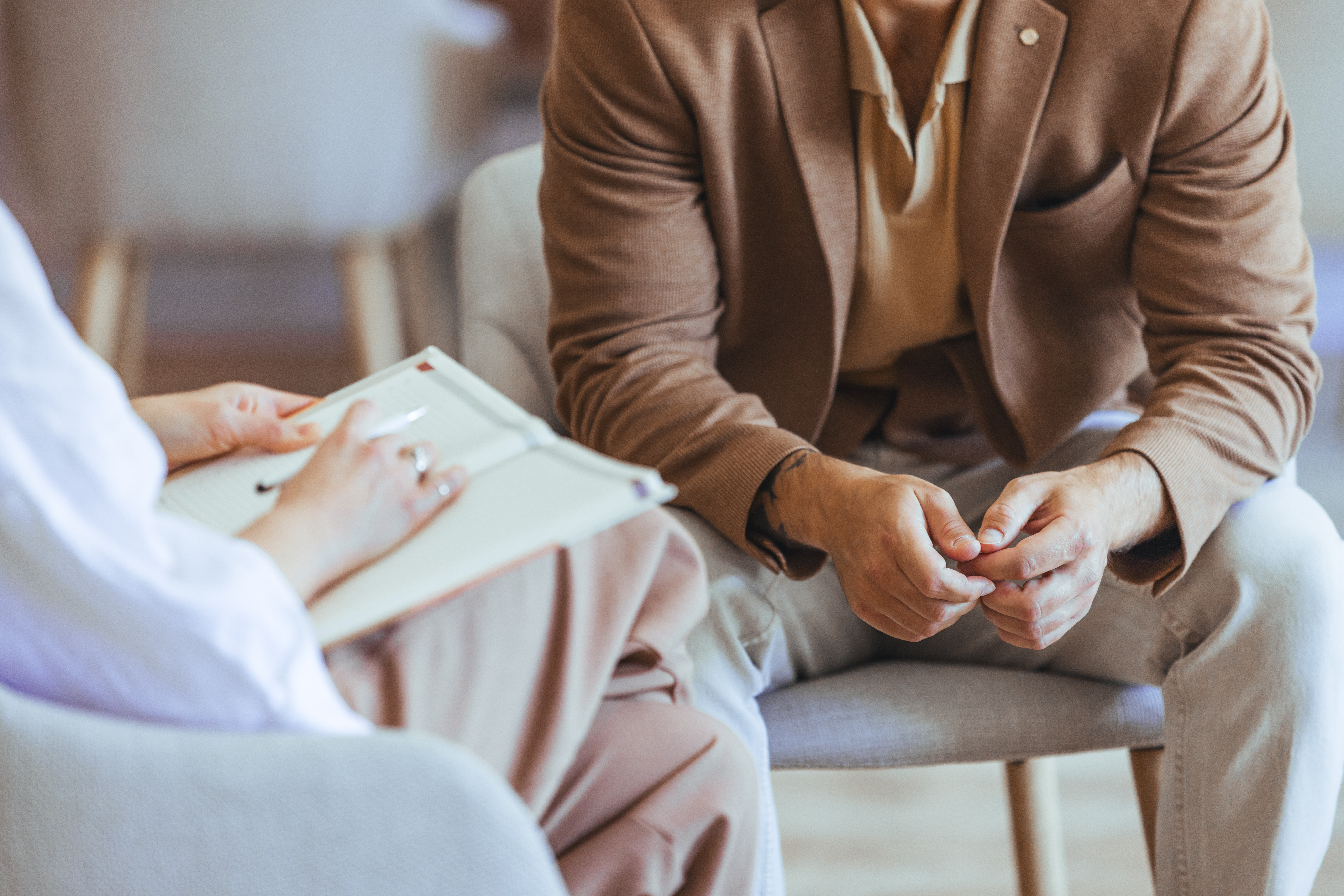 Two Individuals Engaged in Therapy Session for Consultation and Emotional Support