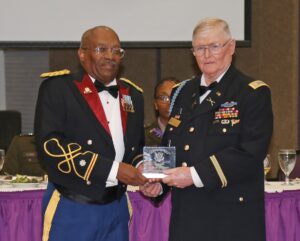 Col. Gayland D. Muse was inducted as a member of the Demon Regiment Hall of Fame. He was unable to attend. The award, presented by Lt. Col. (R) Arthur Smalley, Regimental Chief of Staff for the Demon Regiment Executive Council, was accepted on Muse’s behalf by Maj. (R) Richard Hooter, Marketing Officer for the Demon Regiment Executive Council.