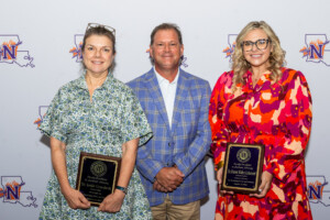 Dr. Leslie Gruesbeck, left, and Dr. Kristen Walker Authement, right, were honored with Faculty Excellence in Academic Advising Awards. Steve Hicks, executive director of Academic Advising Services, center, presented the honors. 