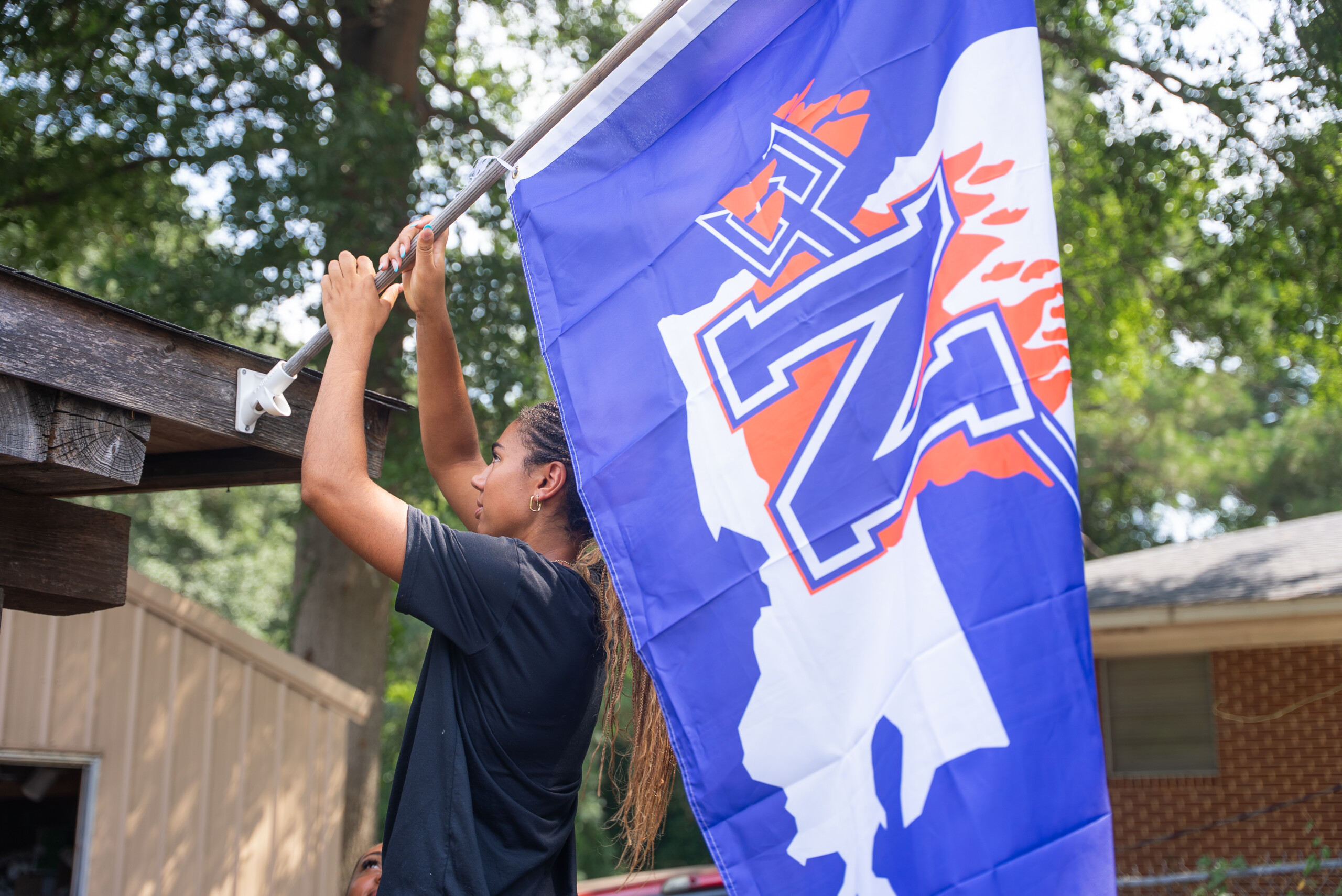 NSU Junior Makenna Tryon, a Lady Demon volleyball player from Waller, Texas, joined fellow student volunteers in distributing NSU flags and signage to Natchitoches homes and businesses July 30. If you would like some Demon swag for your home or office, visit www.nsu.la/purple